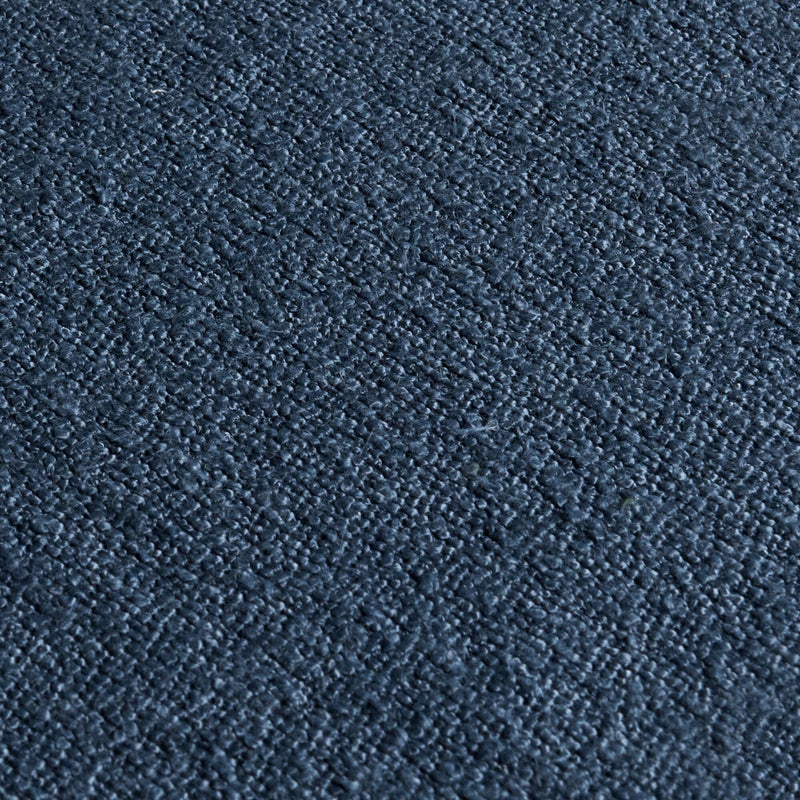 Close-up of navy blue textured carpet upholstery fabric with loop pile and dense woven fibers