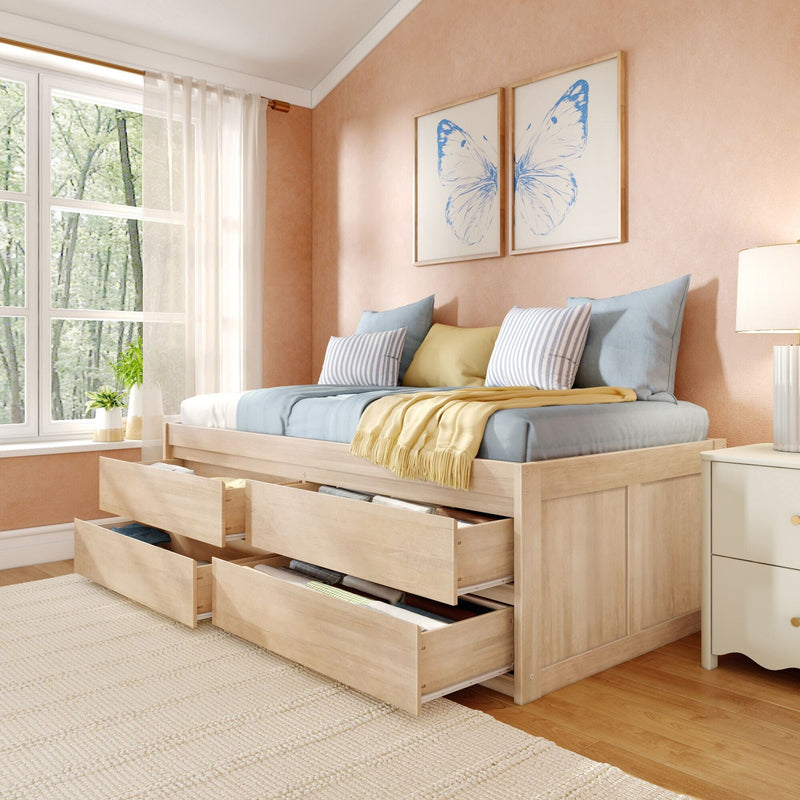 Natural wood storage bed with multiple under-bed drawers, pastel blue and yellow bedding and striped pillows, blue butterfly wall art and sheer curtains in a sunlit cozy bedroom