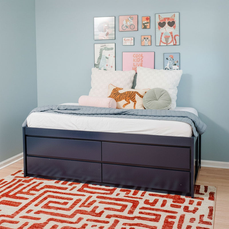 Twin kids' storage bed with navy drawers in pastel blue bedroom, gallery wall art, tiger accent pillow and red geometric rug