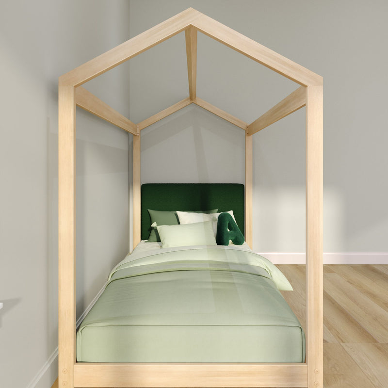 Wooden house-frame single bed with green bedding and pillows in a minimalist modern kids' bedroom