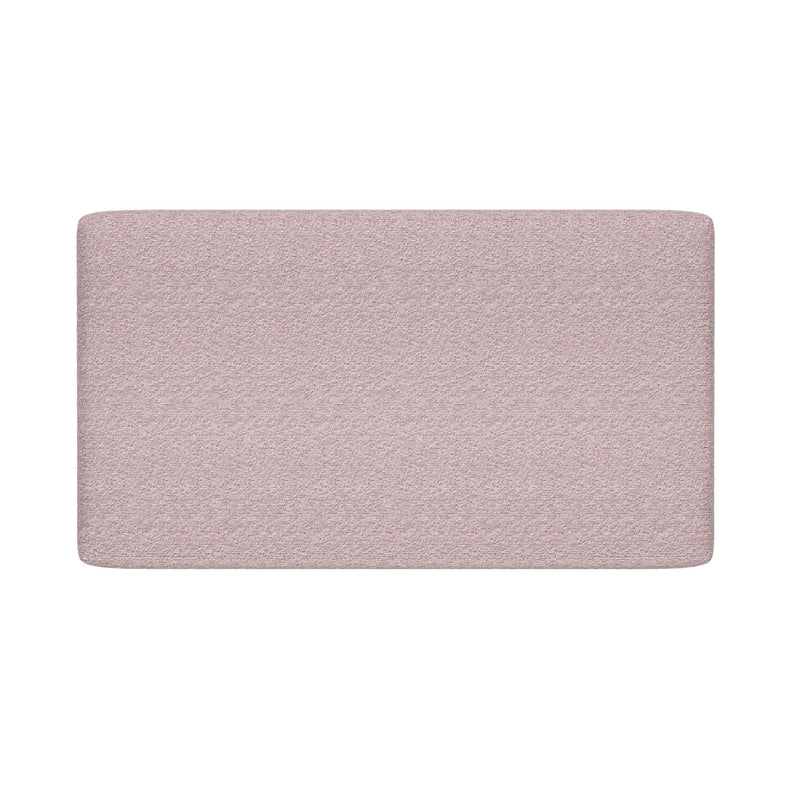 Light pink upholstered headboard with textured fabric and rounded top corners on white background