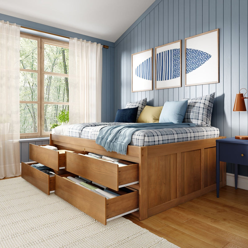 Wooden storage bed with pull-out drawers in coastal blue shiplap bedroom, plaid bedding, sheer curtains and natural window light