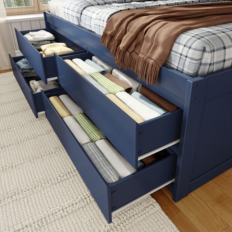 Blue platform bed with multiple under-bed storage drawers neatly filled with rolled and folded linens, plaid bedding and a brown throw — space-saving bedroom storage solution