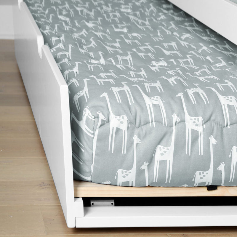 Gray giraffe-print kids duvet cover on white modern toddler bed frame with wooden slats, nursery bedding