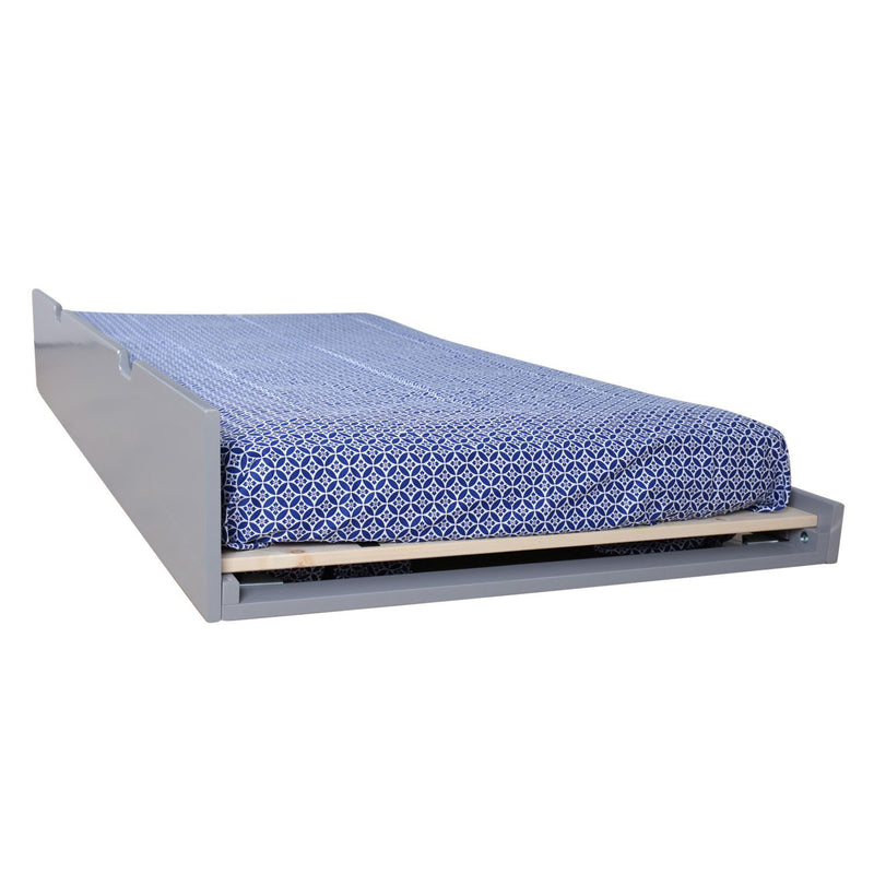 Gray pull-out trundle bed with blue geometric patterned fitted sheet on wooden slats, space-saving single guest bed
