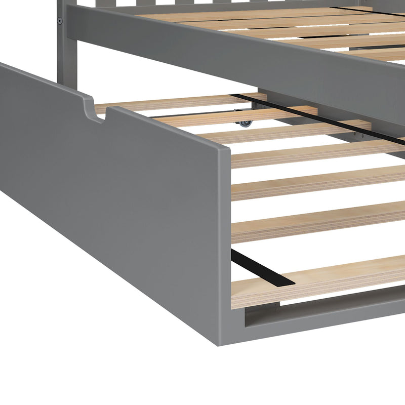 Gray wooden bed frame close-up showing exposed plywood slats and black central metal support strap on a modern platform bed base