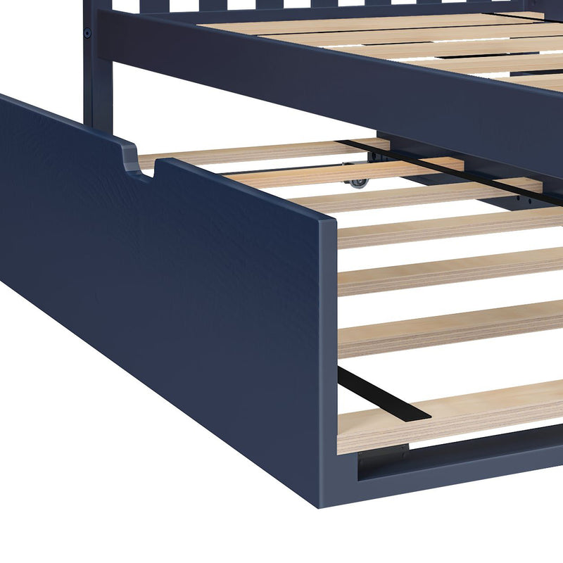 Close-up of navy blue wooden platform bed frame with light wood slats and under-bed trundle on caster wheels