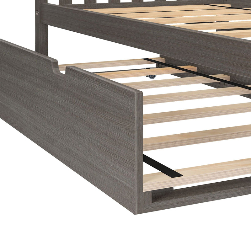 Close-up of gray wood platform bed frame with wooden slats, central metal support strap and underbed trundle wheel — modern rustic bedroom furniture
