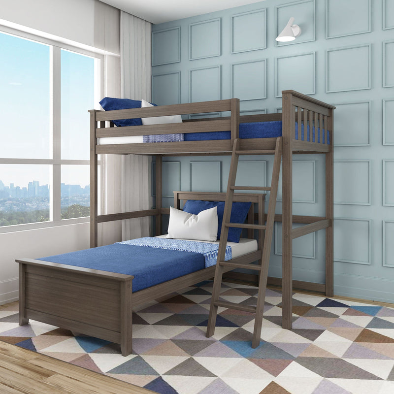 Solid wood twin-over-twin bunk bed with ladder and navy-blue bedding in a bright children's bedroom with large window, pale-blue paneled wall and geometric rug