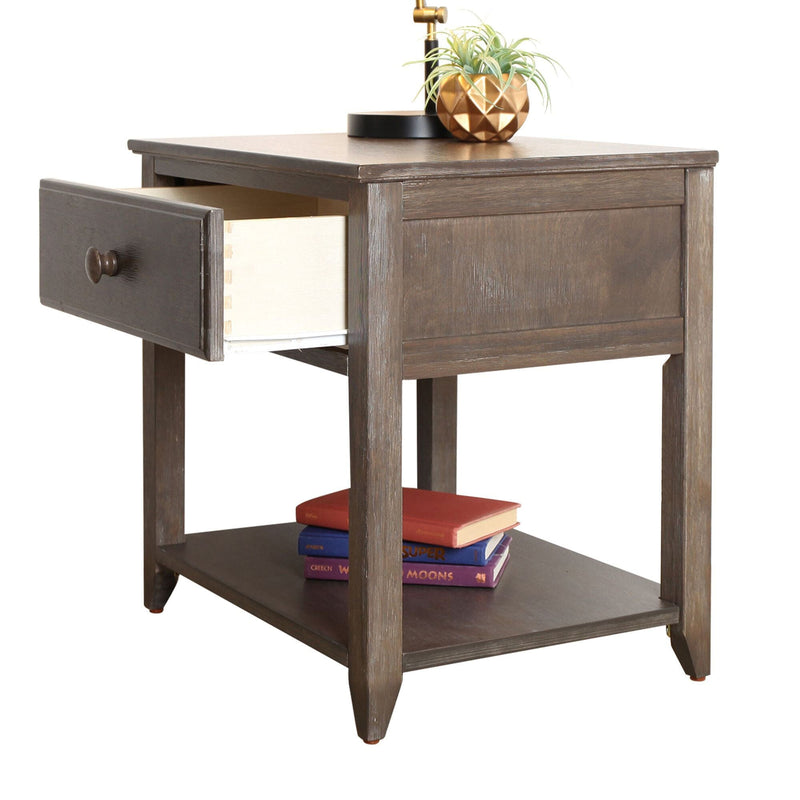 Brown wooden nightstand end table with open drawer, lower shelf with stacked books, brass lamp and gold planter with succulent, modern farmhouse style