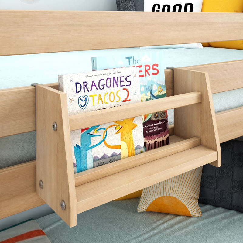 Light wood kids bunk bed with built-in bookshelf holding children's picture books, teal bedding and sun-print pillow — wooden bunk bed storage and decor