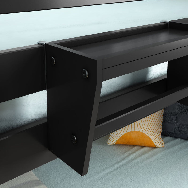 Close-up of black metal bunk bed frame and safety guardrail with teal bedding and sun-print accent pillow