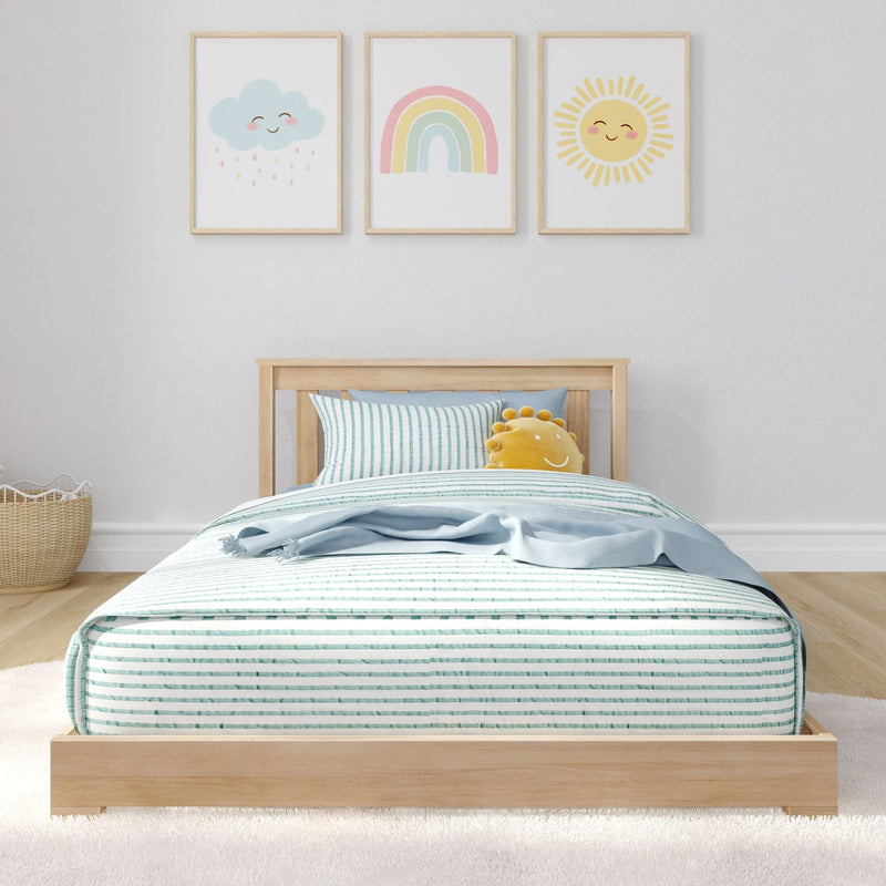 Children's nursery bedroom with wooden twin bed, striped bedding and pastel wall art prints of smiling cloud, rainbow and sun