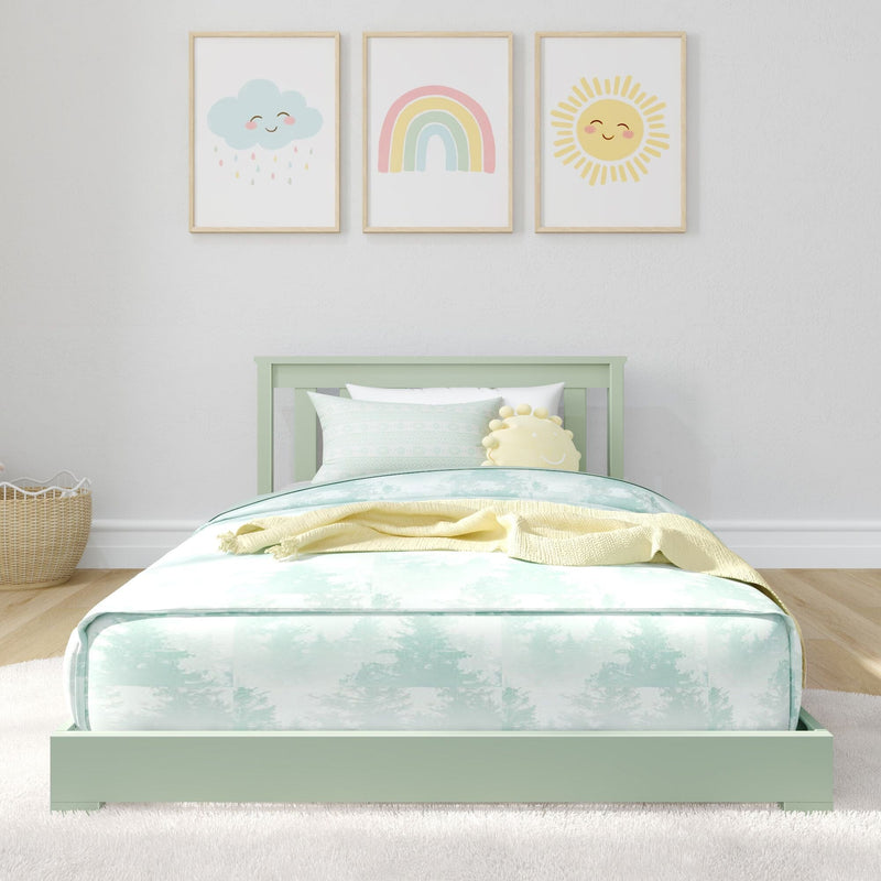 Pastel nursery decor with three framed prints (smiling cloud, rainbow, sun) above a mint green bed with pastel bedding and sun plush pillow