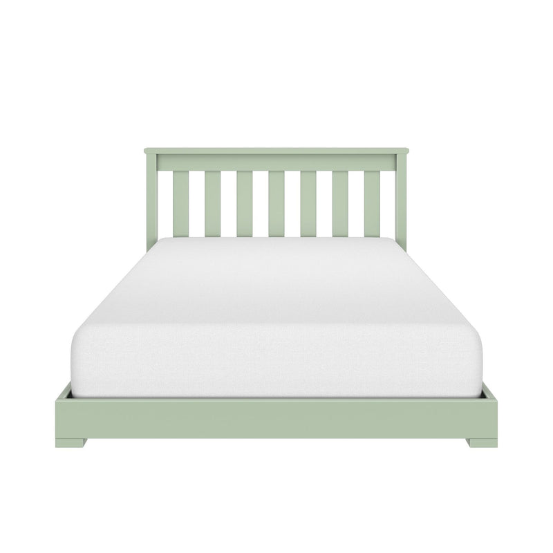 Green wooden twin bed frame with slatted headboard and white mattress on white background