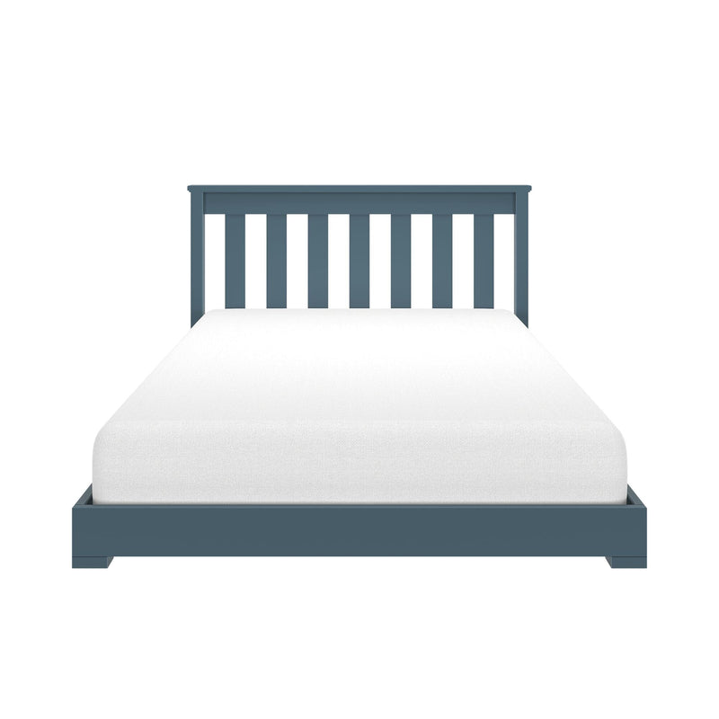 Blue wooden slatted twin bed frame with white mattress on a minimalist platform — modern single bed headboard close-up