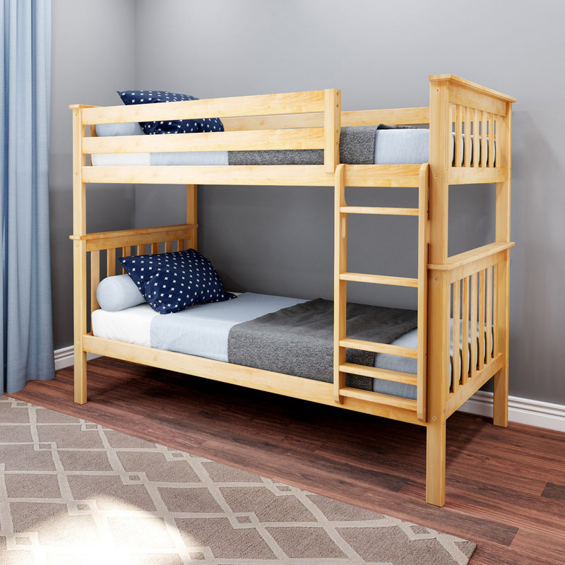 Natural pine twin-over-twin bunk bed with ladder in modern kids' bedroom, navy star pillows and gray bedding on hardwood floor