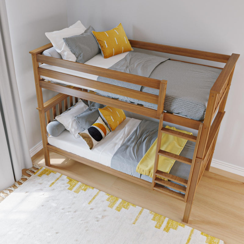 Wooden bunk bed with natural wood frame, ladder and space-saving design, styled with grey knit blankets and yellow accent pillows in a modern kids' bedroom