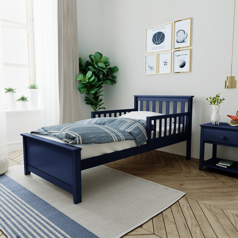 Navy blue child's bed in modern kids' bedroom with striped bedding, sports-themed framed wall art, indoor plants, blue nightstand and hardwood floors