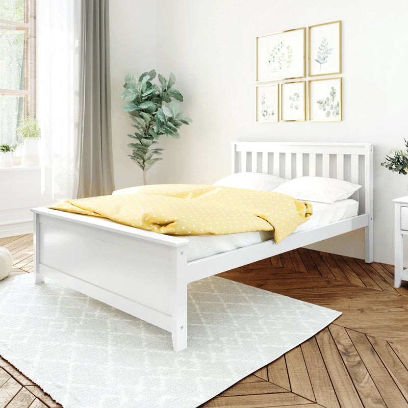 Bright modern bedroom with white wooden bed, yellow polka dot duvet, fiddle leaf fig and framed botanical prints