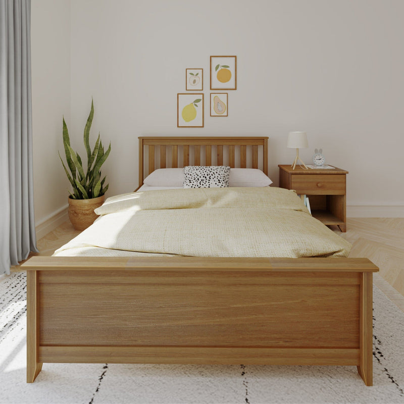 Minimalist modern bedroom with wooden bed frame, neutral bedding, bedside table with lamp and alarm clock, potted snake plant and framed fruit wall art