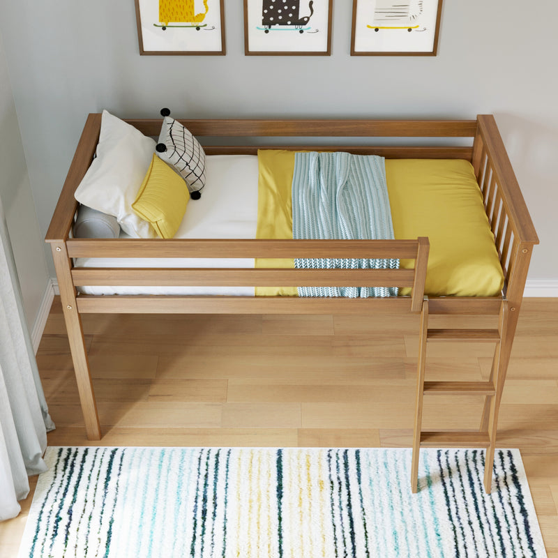 Modern wooden loft bed with yellow bedding, patterned throw and pillows, ladder and striped area rug in a bright child's bedroom with framed cat prints