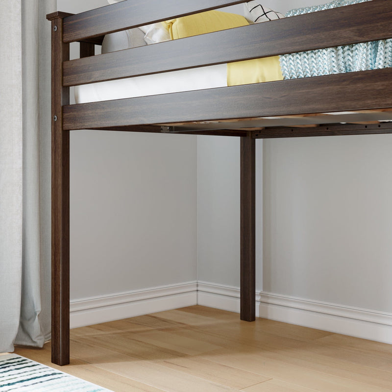 Dark walnut solid wood loft bed frame corner with slatted guardrail, raised bunk design over light hardwood floors, neutral curtains and pale gray walls