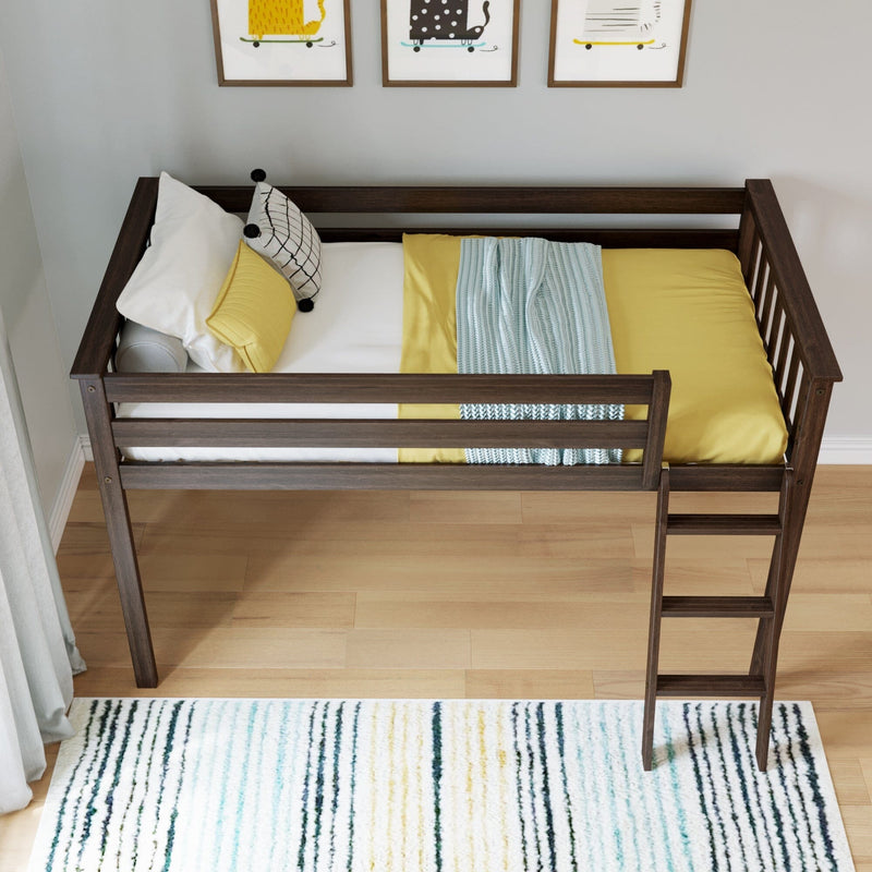 Children's dark wood loft bed with ladder, yellow bedding, patterned pillows and blue knit throw, hardwood floor, striped rug and framed wall art