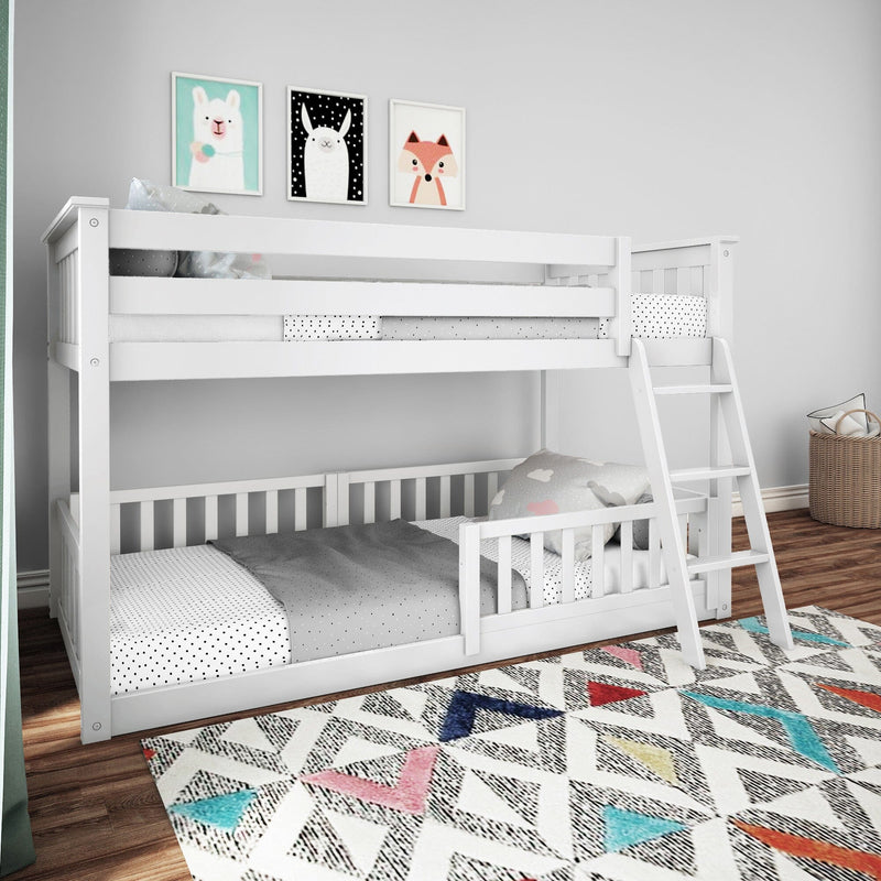 White twin-over-twin bunk bed with ladder and guardrail in kids' bedroom with colorful geometric rug and animal wall art