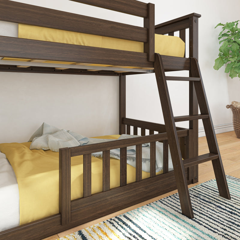 Dark walnut wooden bunk bed with ladder and yellow bedding in a modern kids' bedroom on hardwood floor with striped area rug and potted plant