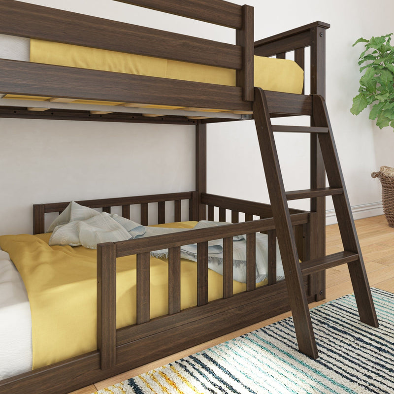 Dark walnut wood twin-over-full bunk bed with ladder, yellow bedding and light blue throw in a modern children's bedroom with striped rug and potted plant