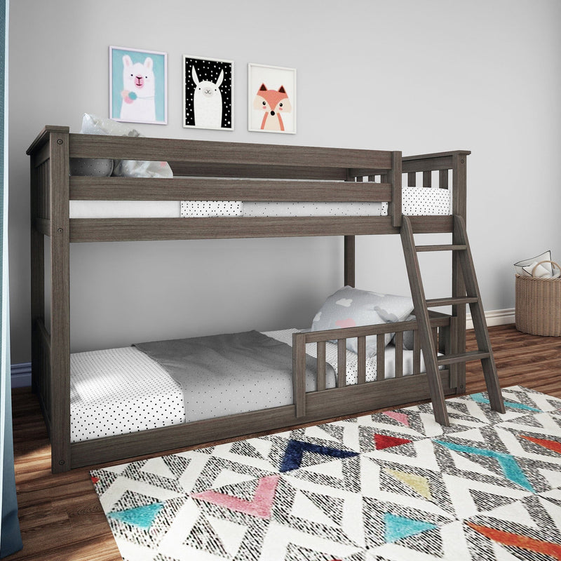 Gray wooden twin-over-twin bunk bed with ladder and safety rails in modern kids bedroom with patterned rug and animal wall art