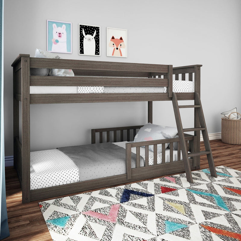 Modern gray wooden twin-over-twin bunk bed with ladder in kids' bedroom, polka-dot bedding, animal wall art and colorful geometric rug