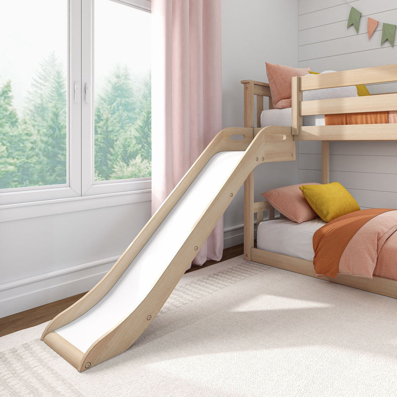 Wooden kids bunk bed with slide in a bright children's bedroom by a large window, pastel pink curtains, orange and yellow pillows, neutral rug and modern kids room decor