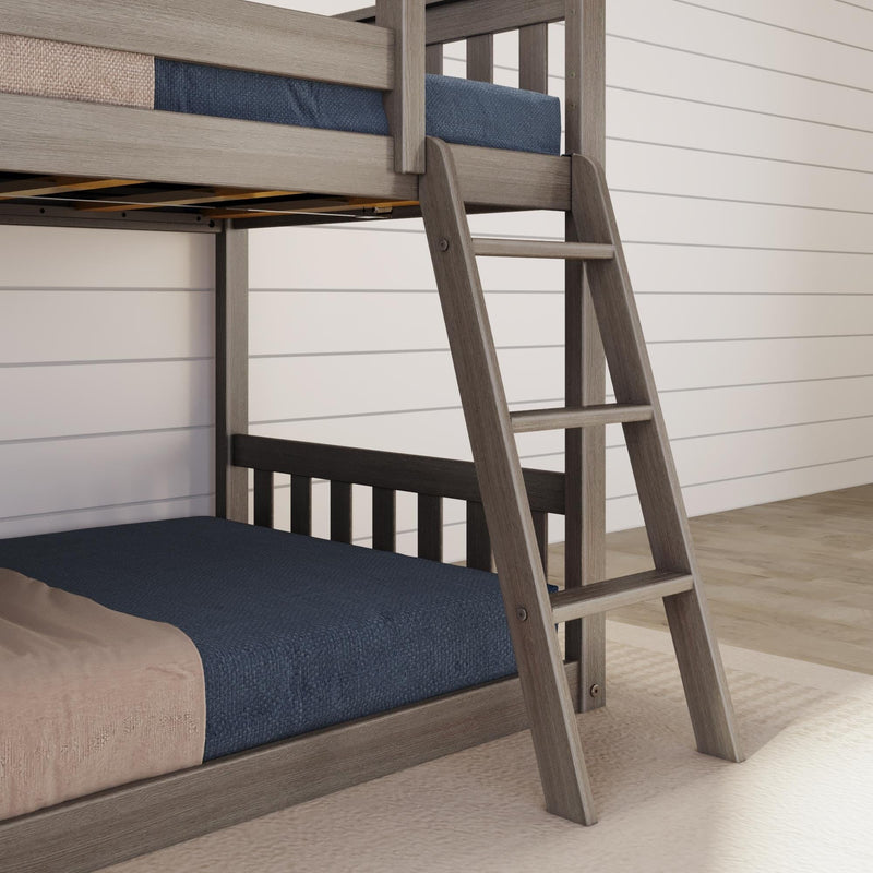 Grey-wash wooden twin bunk bed with angled ladder and navy bedding against white shiplap wall, space-saving farmhouse style