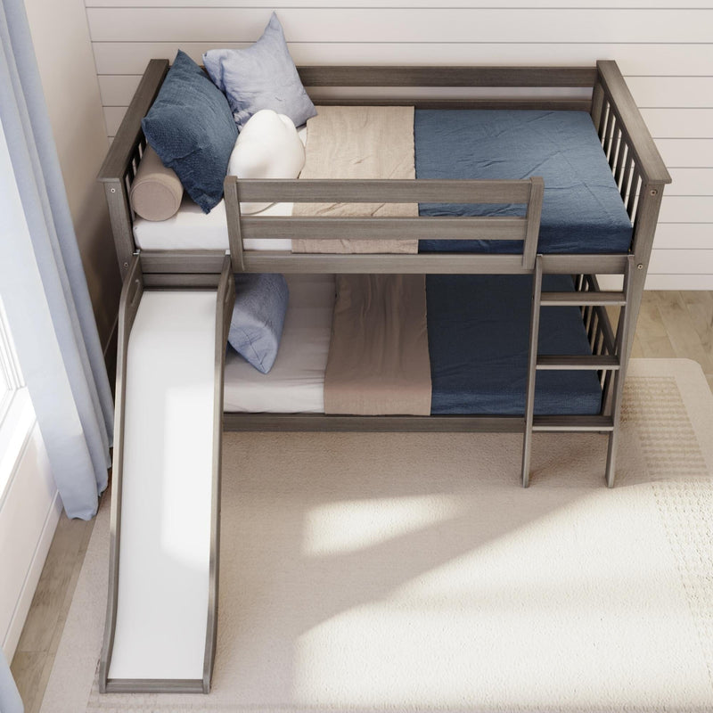 Top view of a gray wooden bunk bed with slide and ladder, styled with blue and beige bedding and pillows in a modern kids' bedroom — space-saving loft bed design