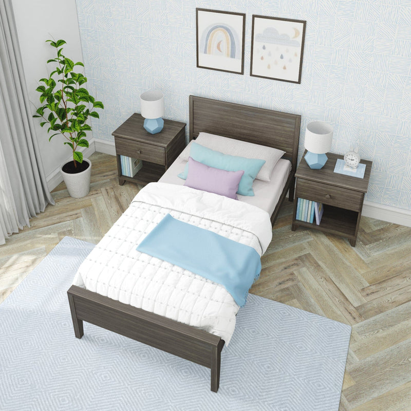 Cozy pastel bedroom with wooden twin bed, nightstands, blue lamps, potted plant, rainbow wall art and herringbone wood floor.
