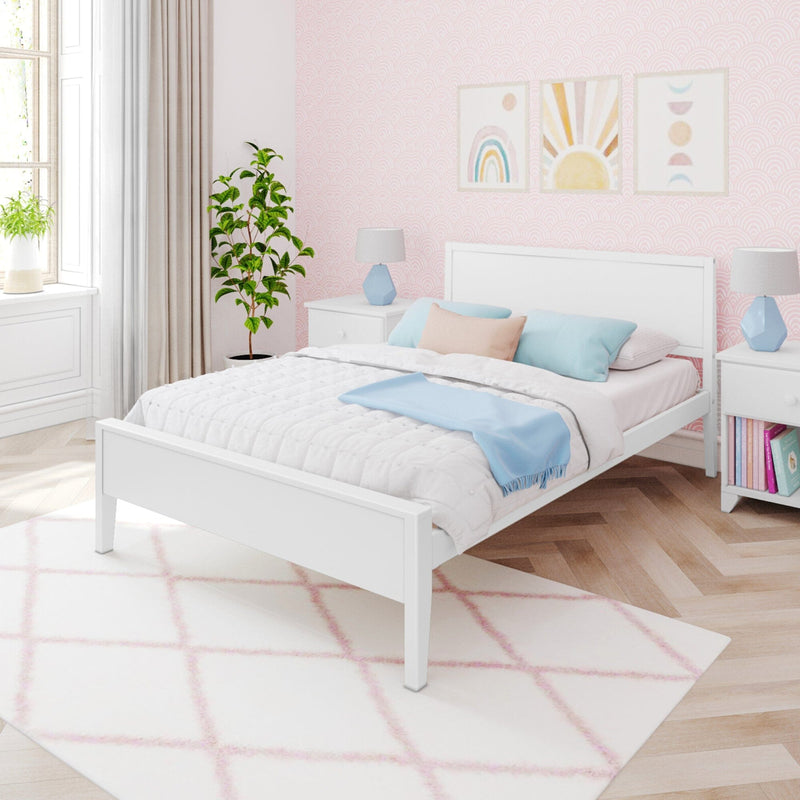Pastel pink kids bedroom with white bed, light blue pillows, blush geometric rug, scallop patterned wallpaper and framed rainbow and sun wall art