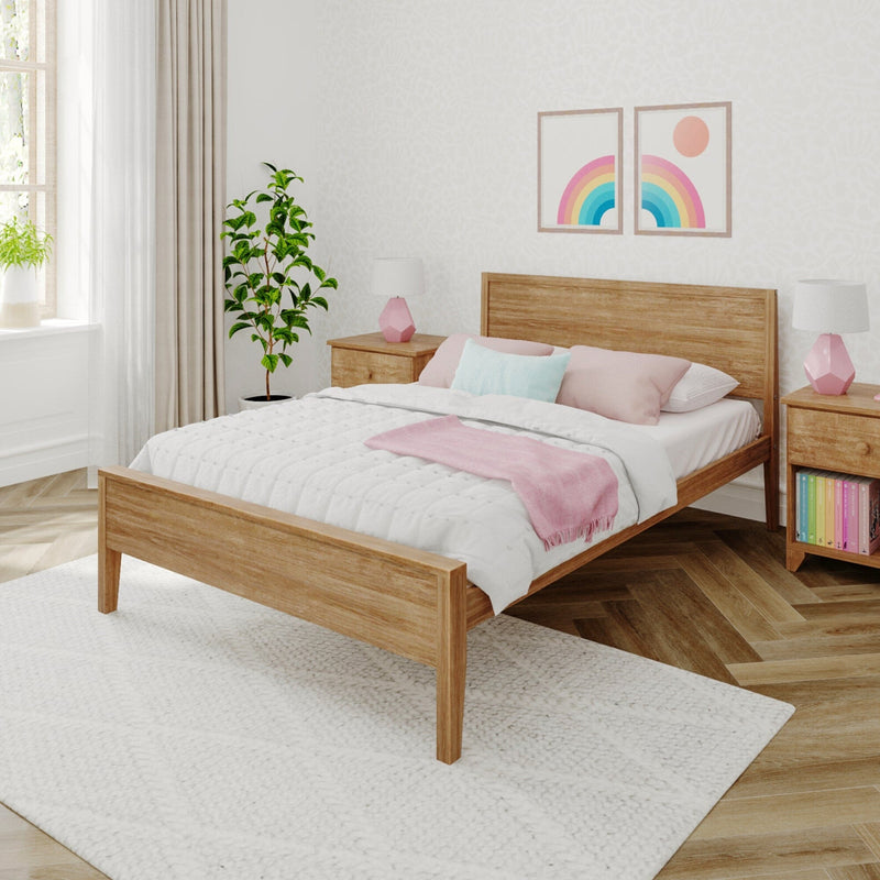 Cozy modern pastel bedroom in Scandinavian style with wooden bed frame, white quilted bedding, pink throw and pillows, rainbow wall art, bedside lamps and potted plant.