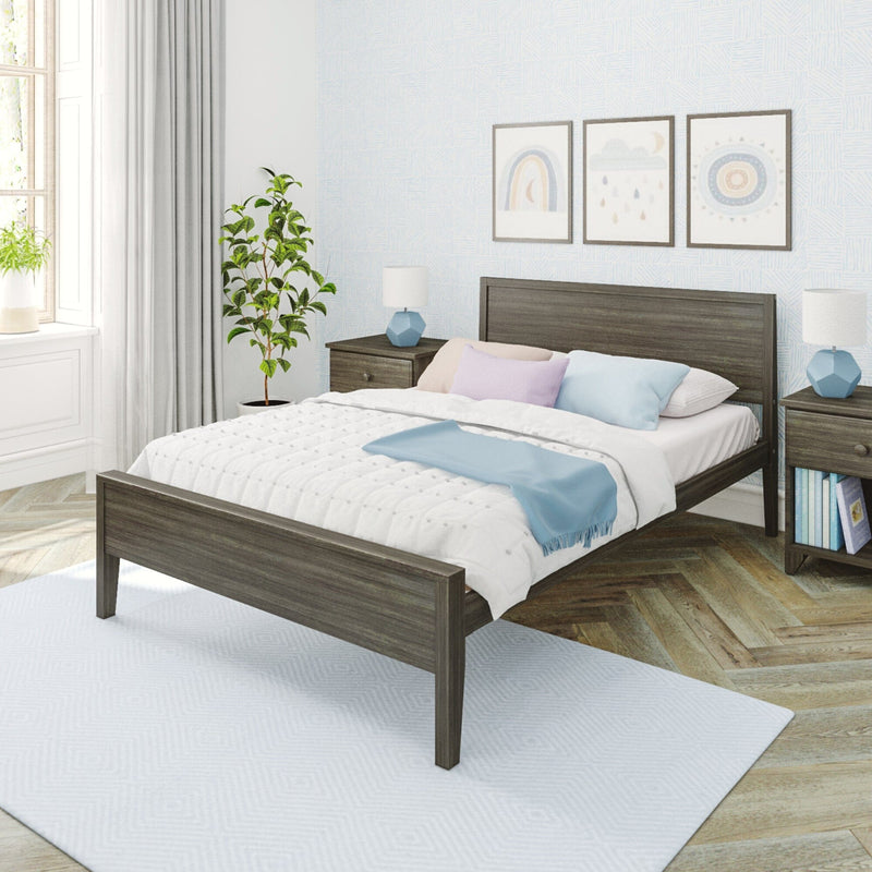 Modern cozy bedroom interior with gray wood bed frame, white quilt and pastel pillows, blue throw, matching nightstands and lamps, framed wall art, potted plant and natural window light
