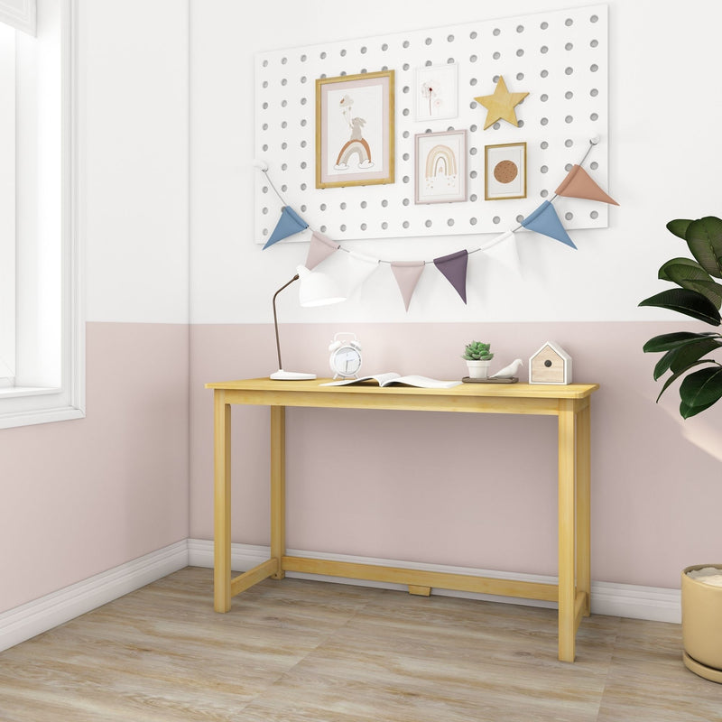 Scandinavian kids study nook with light wood desk, white lamp, alarm clock, succulent and birdhouse beneath a white pegboard wall displaying pastel framed nursery wall art, wooden star and colorful bunting in a pink and white children's room