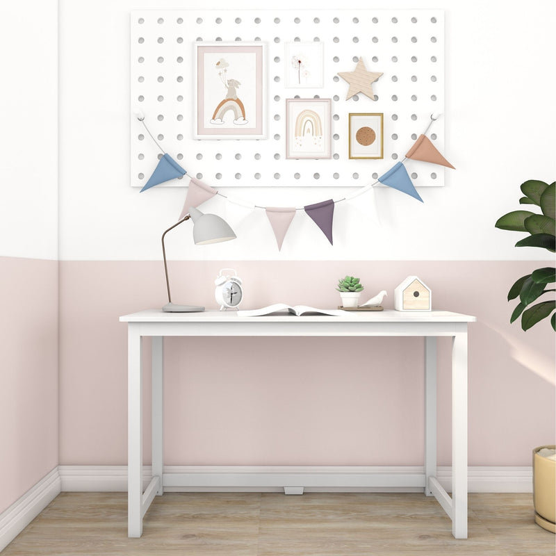 Pastel children's desk and workspace with white pegboard, framed rainbow prints, wooden star, colorful bunting flags, desk lamp, alarm clock, succulent and birdhouse, minimalist nursery decor