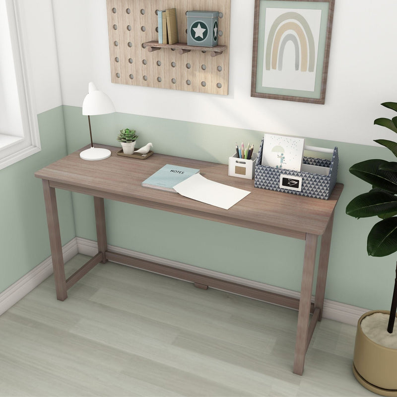 Minimal light wood writing desk in a mint green small home office with white lamp, succulent, notebook and patterned desk organizer, Scandinavian style