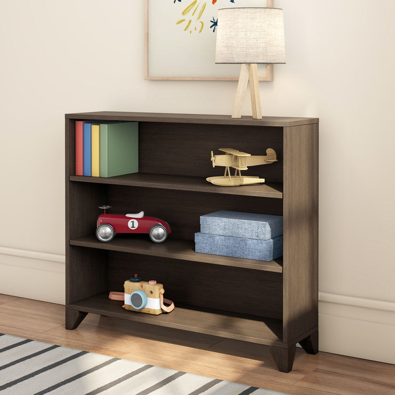 Children's nursery bookshelf with wooden airplane and red toy car, colorful books, blue storage boxes and tripod table lamp — kids room decor and storage