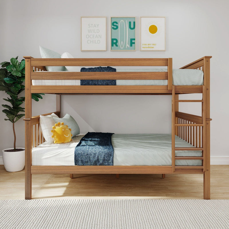 Wooden twin bunk bed in modern coastal children's bedroom with neutral bedding, navy throw, sun plush pillow, potted plant and three framed ocean-themed prints