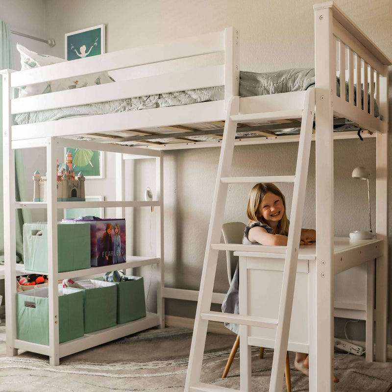 White wooden loft bed with ladder and built-in desk in a pastel kids' bedroom, mint storage bins and a smiling child at the desk