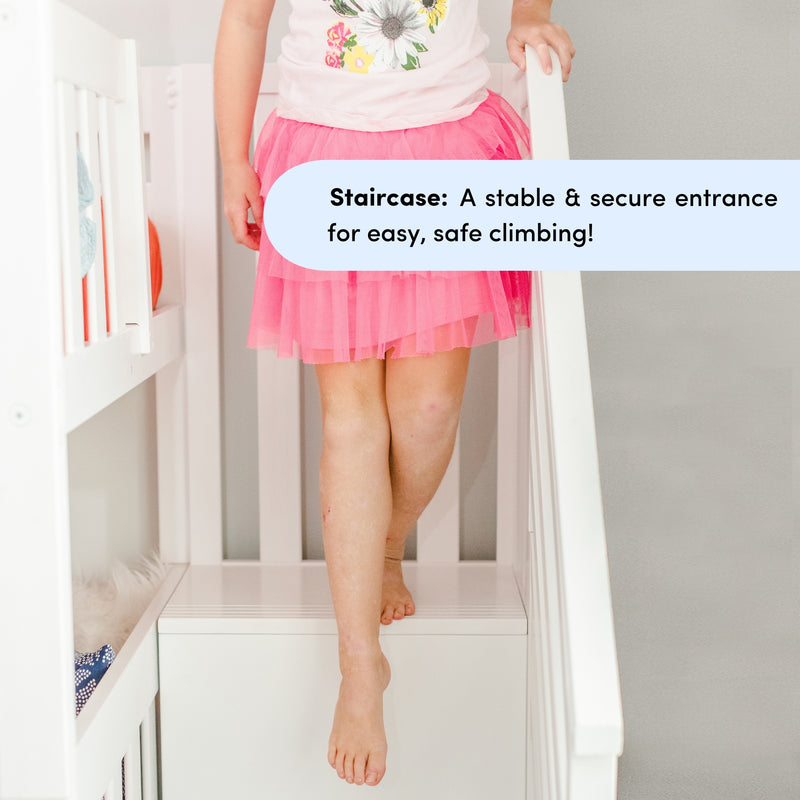 Young child in pink skirt descending white nursery staircase barefoot while using a handrail and built-in storage steps, showcasing a child-safe staircase