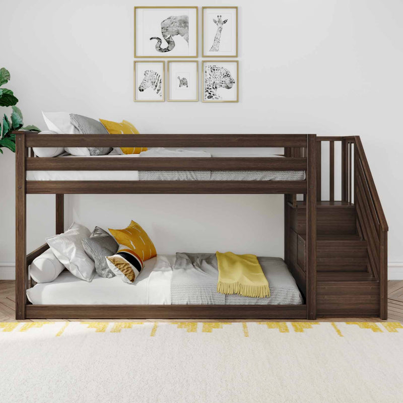 Modern dark-wood bunk bed with staircase in a children's bedroom, white bedding and yellow accent pillows, animal-themed framed wall art and cozy throw for nursery or kids' room décor