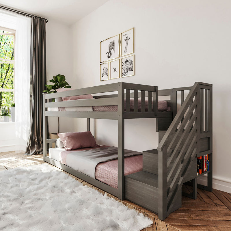 Modern kids bedroom with gray wooden bunk bed and stairs, pink bedding, built-in bookshelf, animal wall art, white shag rug