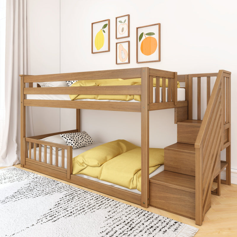 Modern wooden bunk bed with staircase and built-in storage, yellow bedding and polka-dot pillows in a bright children's bedroom with fruit-themed wall art.